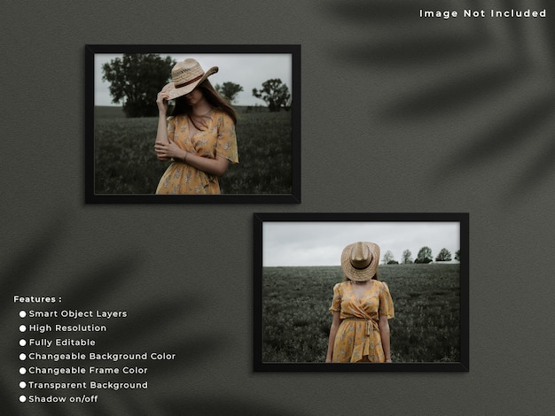 Two black horizontal photo frame mockup hanging on wall background with shadow.