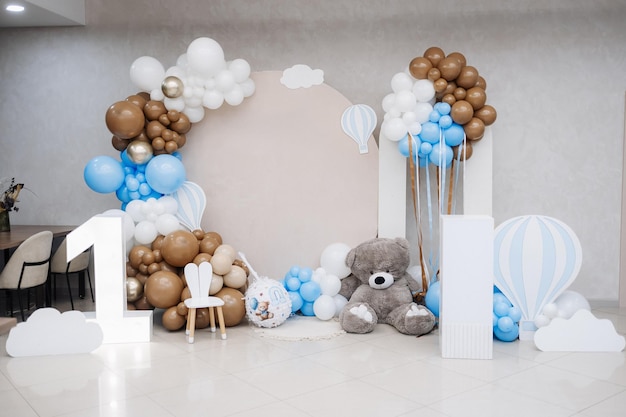 Large photo zone for a childrens birthday party with helium white balloons bright celebration of a childrens birthday party with blue balloons