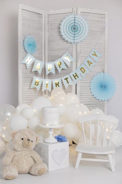 Photo zone with decor for kids happy birthday party with balloons paper garlands and toys