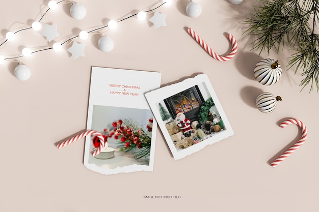 Top view christmas papers with pine leafs and candy mockup