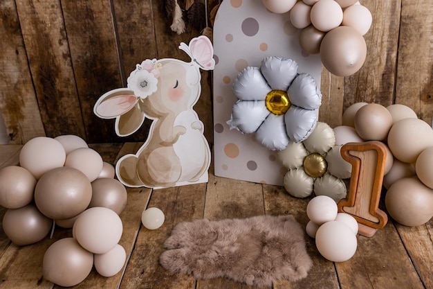 Adorable bunny first birthday photoshoot setup with neutral balloons