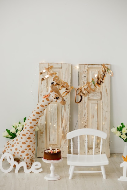 Decor for children in honor of the first birthday giraffe toy a small chair children room