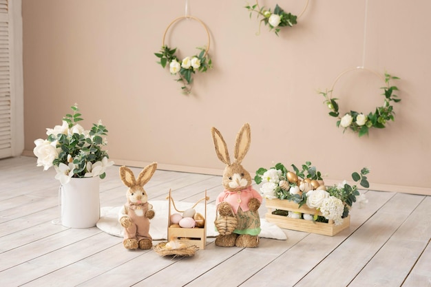 Easter hay bunnies mother and son in an easter decorative composition eggs flowers