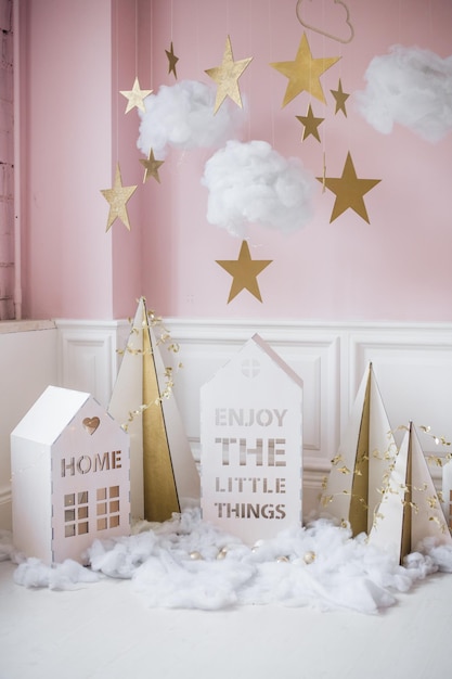 New year decoration tiny christmas houseschristmas background with white house snowflakes star garlands and decorations christmas card