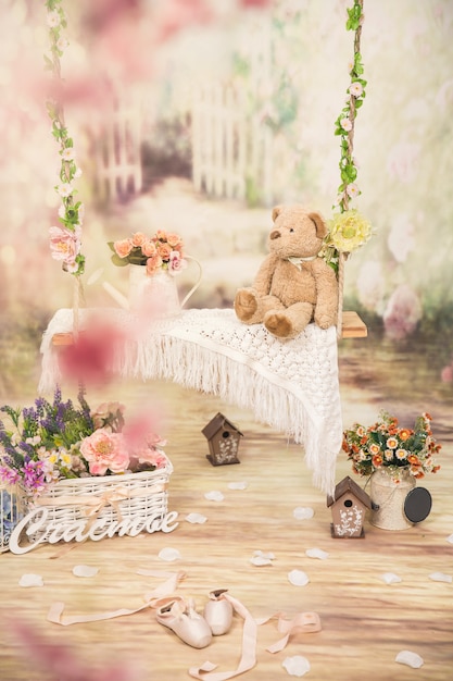 Swing with flowers and teddy in the studio