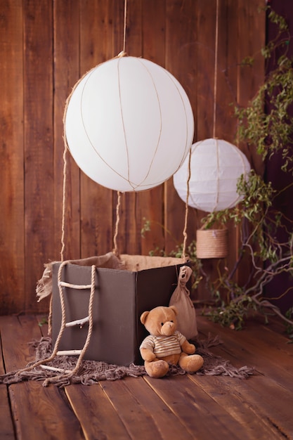 Teddy bear with a balloon on a wooden background