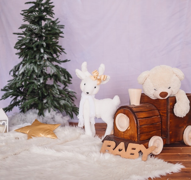 Wooden train with a bear and white toy deer